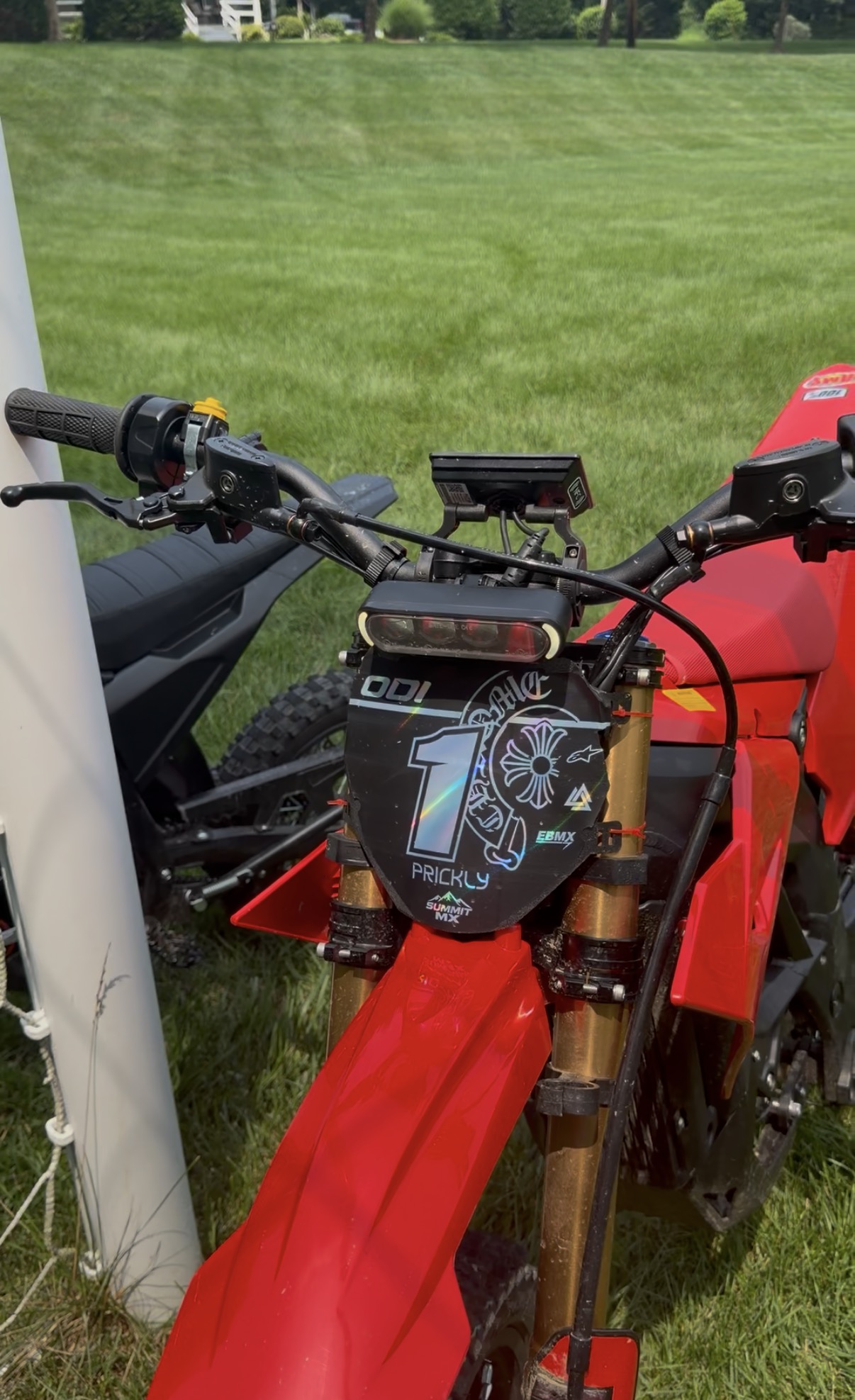 An ODI front number plate installed on an e-moto